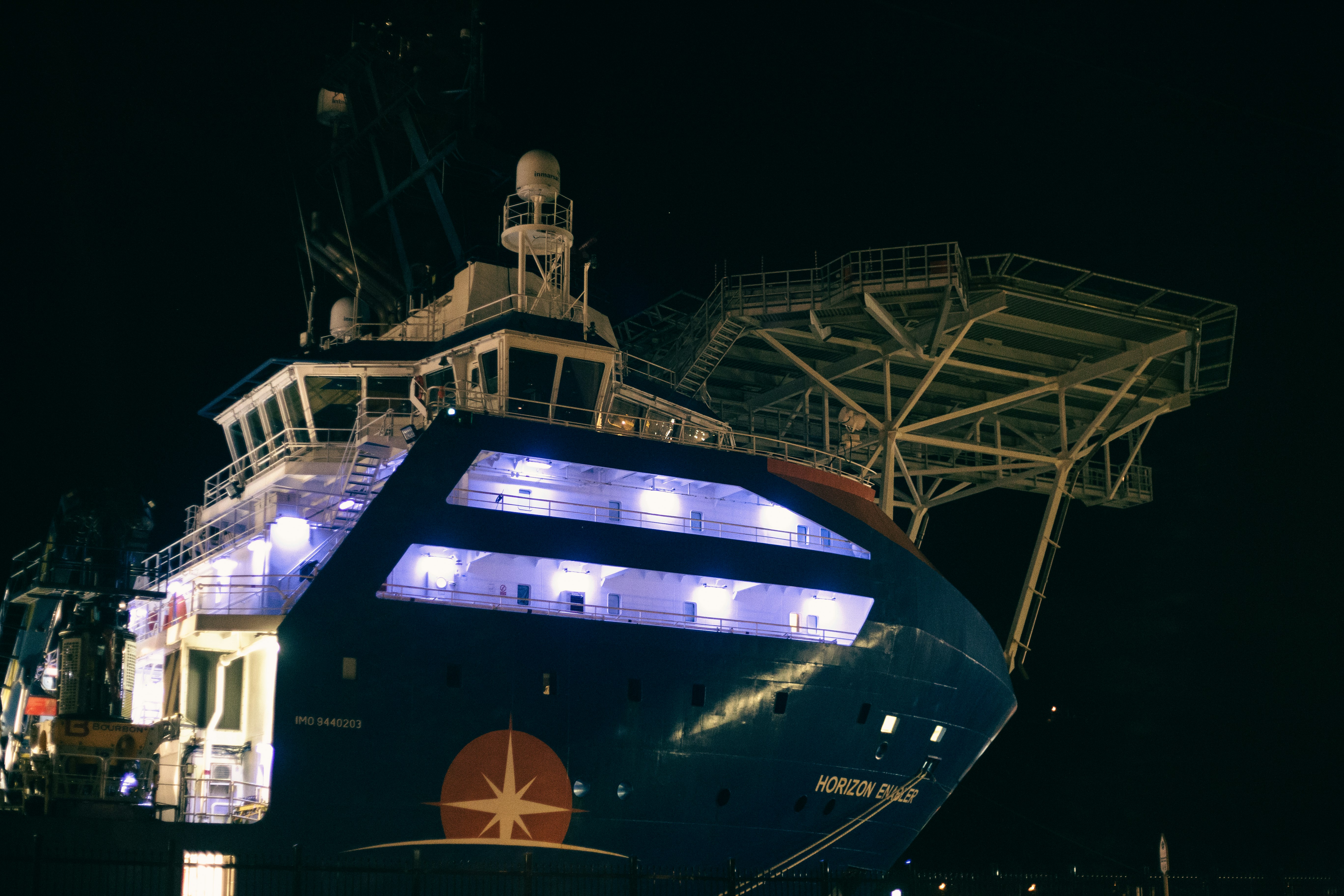 blue and white ship on dock during night time